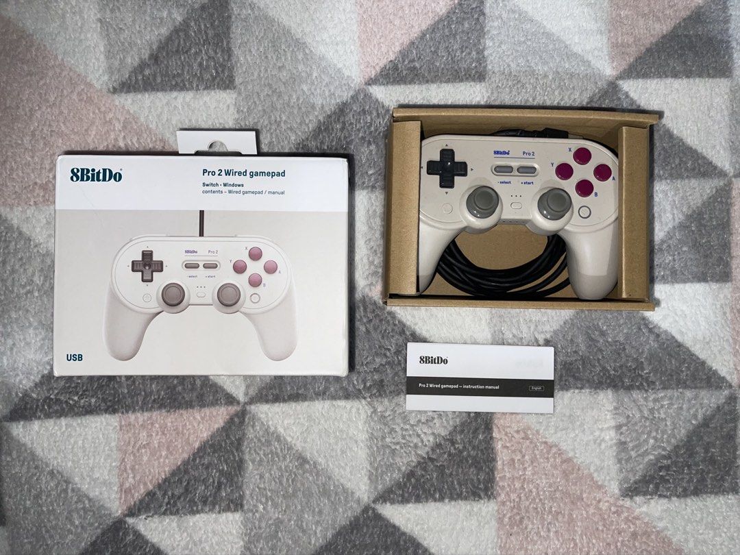 8BitDo Pro 2 Wired Gamepad Controller for Switch Windows (Category: Controllers) located in Quezon City. Submitted by mariikari (Listing ID 1468867599, Image 3). Description: - Model: 8BitDo Pro 2 Wired Gamepad - Color: Beige body, dark red buttons, black D-pad - Compatibility: Nintendo Switch and Windows - Condition: Like new, tested once, zero scratches - Inclusions: original box, and instruction manual.
