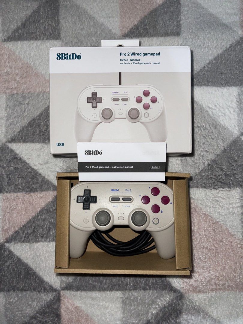 8BitDo Pro 2 Wired Gamepad Controller for Switch Windows (Category: Controllers) located in Quezon City. Submitted by mariikari (Listing ID 1468867599, Image 1). Description: - Model: 8BitDo Pro 2 Wired Gamepad - Color: Beige body, dark red buttons, black D-pad - Compatibility: Nintendo Switch and Windows - Condition: Like new, tested once, zero scratches - Inclusions: original box, and instruction manual.