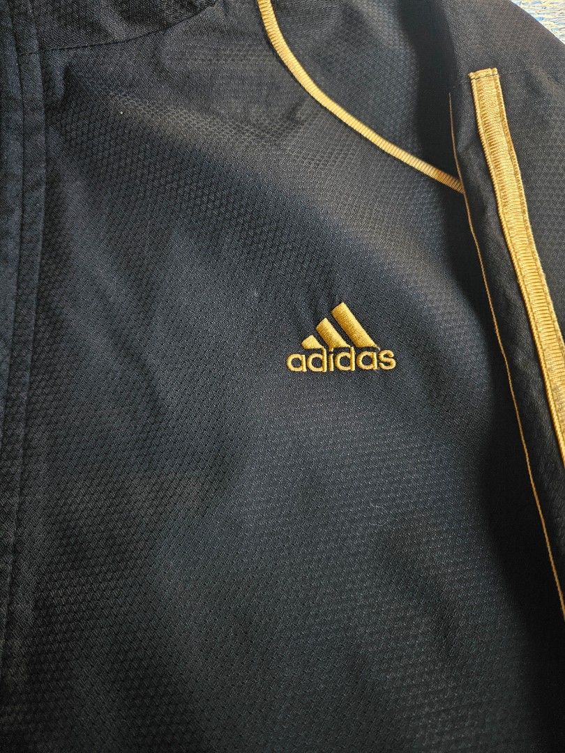 🔥 ADIDAS Performance Track Jacket / Windbreaker 🔥 (Category: Coats, Jackets and Outerwear) located in Las Pinas. Submitted by thriftedjacketsbybang (Listing ID 1468738688, Image 3). Description: 🔥 ADIDAS Performance Track Jacket / Windbreaker 🔥 Upgrade your streetwear rotation with this clean black Adidas full-zip track jacket! Features a classic embroidered gold Adidas performance chest logo, an additional embroidered gold Adidas linear logo