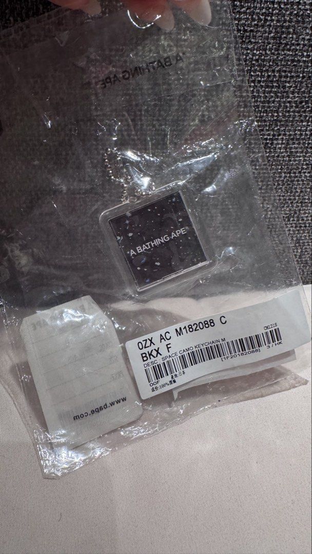 A Bathing Ape Space Camo Keychain M (Category: Shorts) located in Mandaluyong City. Submitted by maelovestoshop (Listing ID 1468874443, Image 2). Description: - 100% Authentic BAPE Space Camo acrylic keychain - Colorway: Black with silver ball chain - Design: Square shape with Ape head graphic on one side and branding on the other - Condition: Brand new in original plastic packaging with store tags attached - Perfect accessory for keys, bags, or 