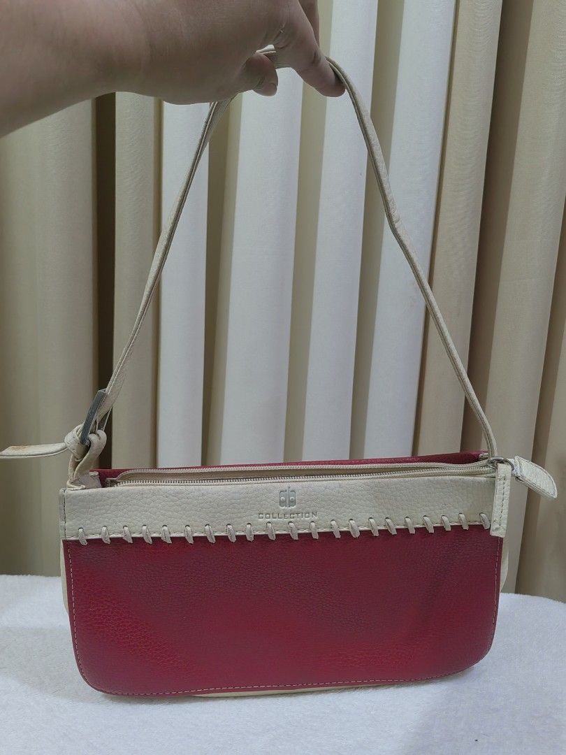 AB Collection Red and White Shoulder Bag (Category: Shoulder Bags) located in Makati City. Submitted by prelovedtreatedwithlove (Listing ID 1468882732, Image 2). Description: - Brand: AB Collection - Color: Red and white two-tone with decorative front stitching - Closure: Secure top zipper closure + exterior back zipper pocket - Strap: Single adjustable cream shoulder strap (normal wear) - Size: Compact rectangular shape, perfect for daily wear -