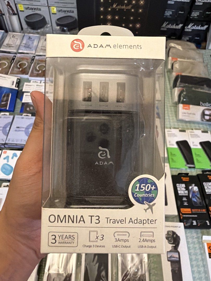 Adam Elements Travel Adapter (Category: Chargers & Cables) located in Quezon City. Submitted by law.1789 (Listing ID 1468915871, Image 1). Description: SRP - 1490 Sale Price - 749 - Brand: Adam Elements - Model: OMNIA T3 Universal Travel Adapter (Black) - Condition: Brand New in Box (Layered Condition 3) - Compatibility: Works in over 150+ countries with US, UK, EU, and AU interchangeable plugs - Multi-Device Charging: Charge up to 3 devices simu