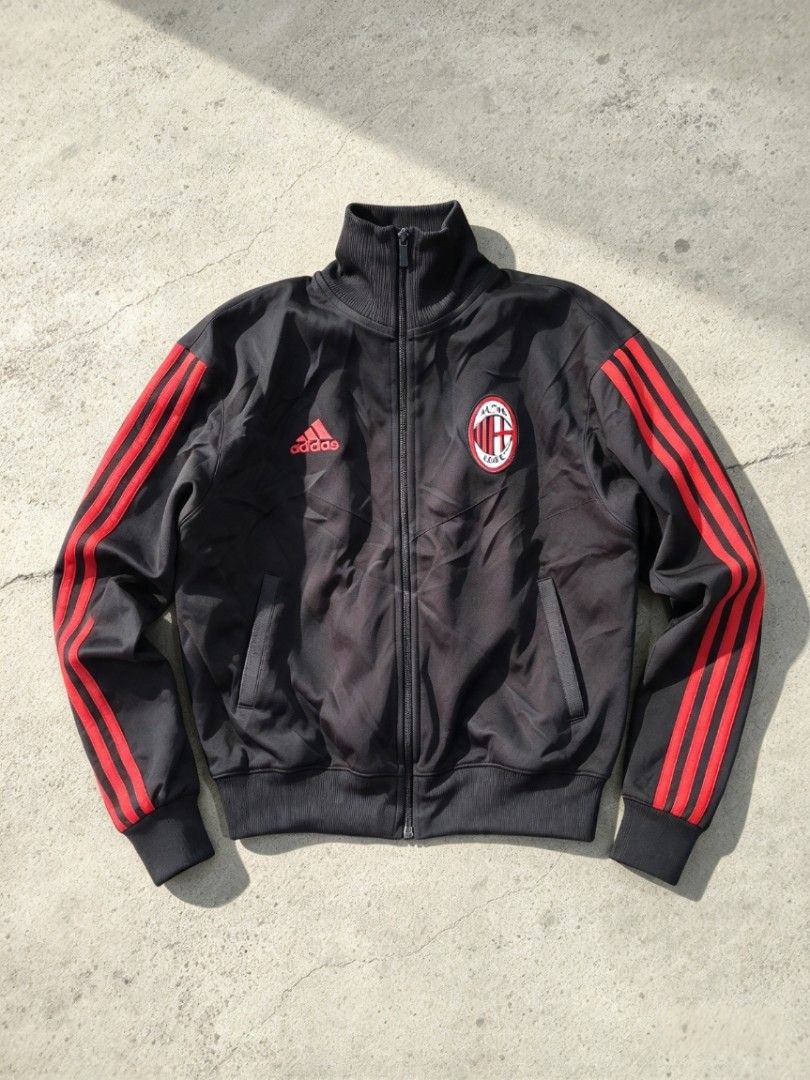 Adidas AC Milan Track Jacket Black Red (Category: Coats, Jackets and Outerwear) located in Manila. Submitted by nisayy13 (Listing ID 1468783649, Image 1). Description: - Authentic Adidas AC Milan track jacket - Classic black colorway with iconic red stripes - Embroidered Adidas logo and official club crest - Full zip front with comfortable ribbed collar, cuffs, and hem - Two convenient side slip pockets - Ideal for football fans and vintage sport