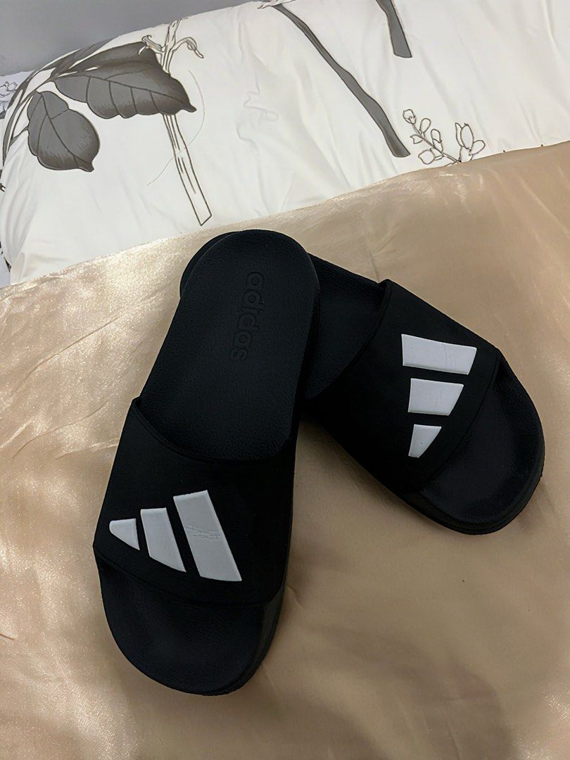 Adidas Black and White Slides (Category: Slippers and slides) located in Cebu City. Submitted by itsmegeecebu (Listing ID 1468766394, Image 1). Description: - Color: Black with white stripes - Size: US 5 / UK 5 / FR 38 / JP 235 - Origin: Made in Vietnam - Condition: Clean, soles show minimal wear - Features: Textured footbed for grip, zigzag outsole pattern - Style: Easy slip-on design for casual days or post-workout - RFS: Runs small on me. 23.5