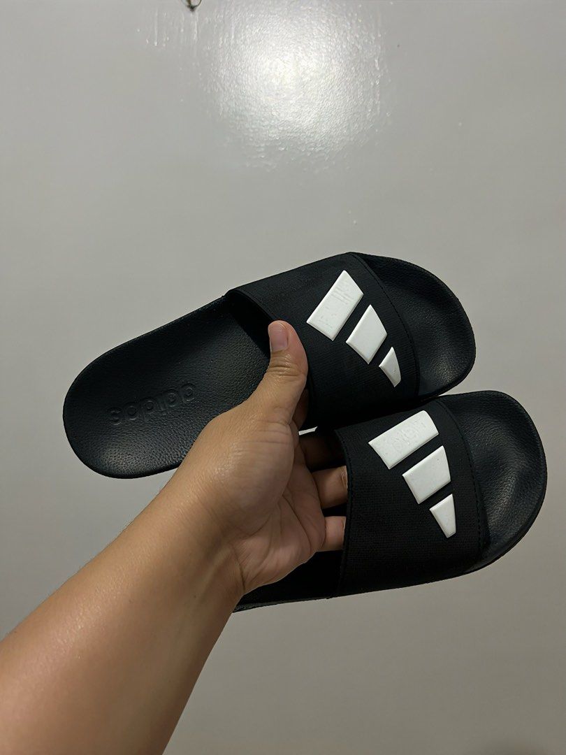 Adidas Black and White Slides (Category: Slippers and slides) located in Cebu City. Submitted by itsmegeecebu (Listing ID 1468766394, Image 3). Description: - Color: Black with white stripes - Size: US 5 / UK 5 / FR 38 / JP 235 - Origin: Made in Vietnam - Condition: Clean, soles show minimal wear - Features: Textured footbed for grip, zigzag outsole pattern - Style: Easy slip-on design for casual days or post-workout - RFS: Runs small on me. 23.5