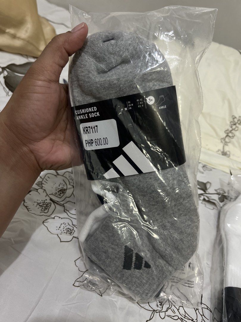 Original Adidas Cushioned Ankle Socks Size M (Category: Socks) located in Cebu City. Submitted by iamgee89 (Listing ID 1468759553, Image 1). Description: - Brand new, still sealed in original packaging with tags attached - Pack of three versatile colors: grey, white, and black - Size M: fits EU 40-42 or US men 7-8.5 - Made with a soft cotton blend for daily comfort - Built-in arch support and heel cushioning, ideal for workouts or casual wear - R