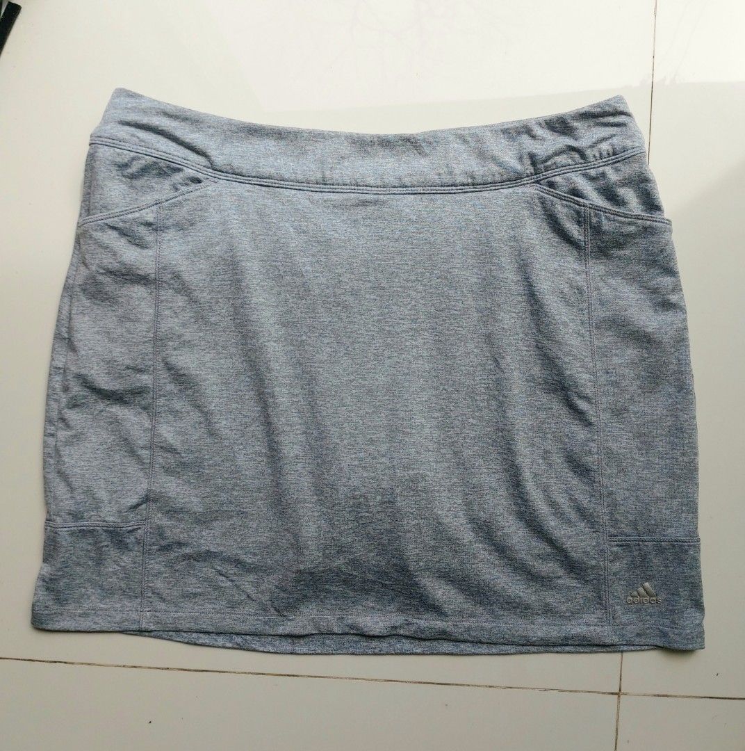 Adidas grey athletic skort with pockets (Category: Activewear) located in Lapu Lapu. Submitted by agnesapm_29813 (Listing ID 1468852817, Image 2). Description: - Brand: Adidas - Color: Grey heathered fabric - Design: Sports skirt with built-in shorts and elastic waistband - Features: Deep front pockets and small back zippered pocket - Details: Silver Adidas logo on front hem - Condition: Clean and well-maintained - Ideal for: Tennis, golf, workou