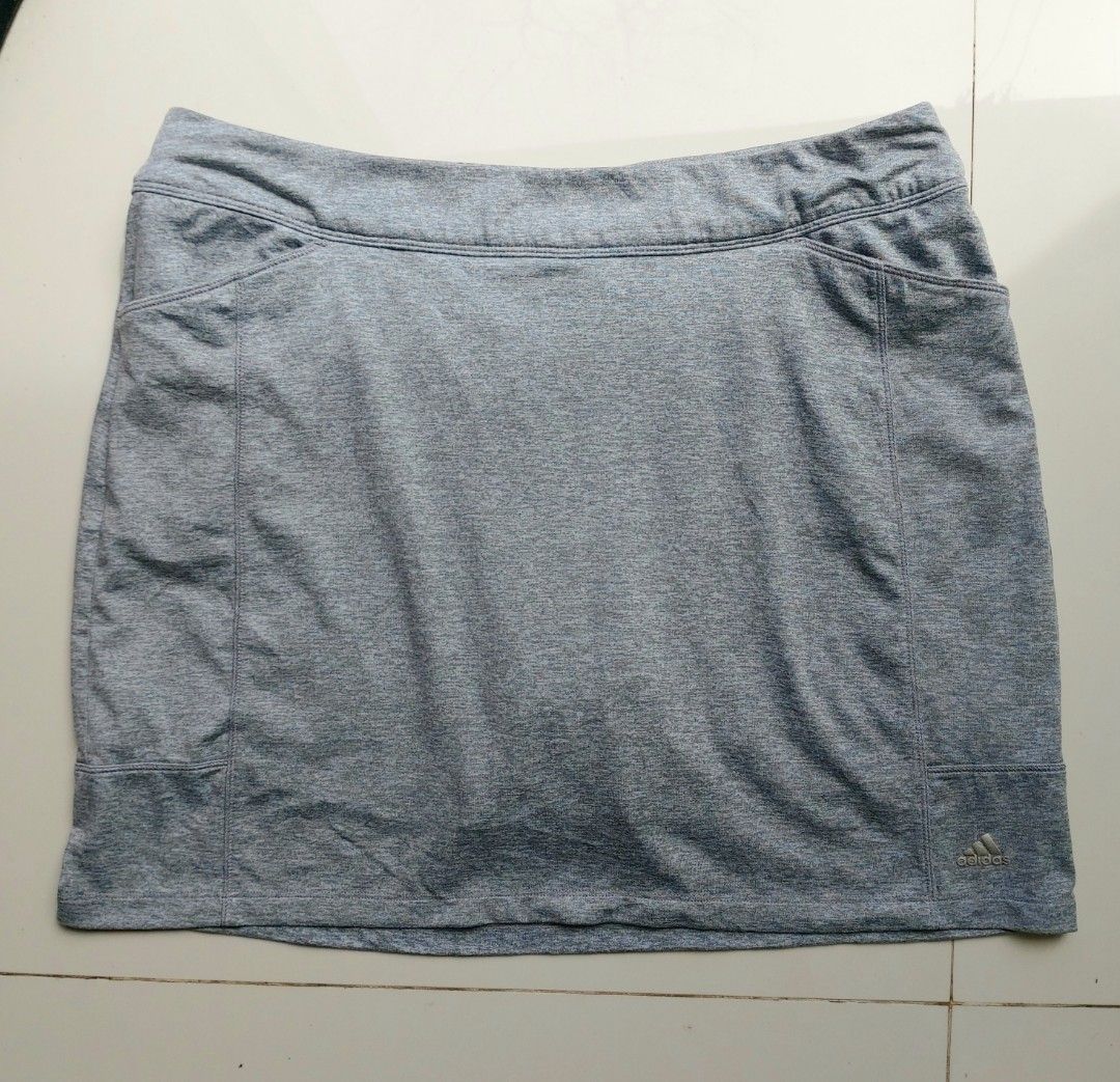 Adidas grey athletic skort with pockets (Category: Activewear) located in Lapu Lapu. Submitted by agnesapm_29813 (Listing ID 1468852817, Image 1). Description: - Brand: Adidas - Color: Grey heathered fabric - Design: Sports skirt with built-in shorts and elastic waistband - Features: Deep front pockets and small back zippered pocket - Details: Silver Adidas logo on front hem - Condition: Clean and well-maintained - Ideal for: Tennis, golf, workou