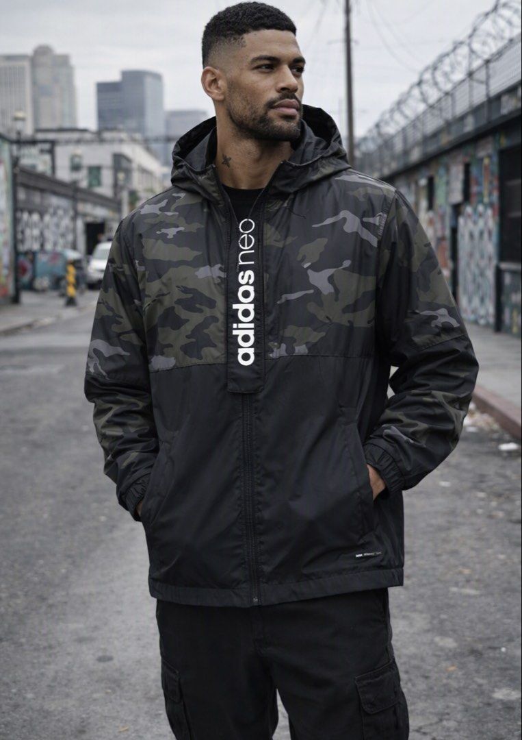 Adidas Neo Camo Windbreaker Jacket (Category: Coats, Jackets and Outerwear) located in Paranaque City. Submitted by cjc0622 (Listing ID 1468747446, Image 1). Description: - Brand/Model: Adidas Neo windbreaker - Design: Black and green camo pattern with a striking vertical logo along the half-zip placket - Features: Attached hood, full-zip closure, and comfortable elastic cuffs - Material: Lightweight fabric, ideal as an outer layer for breezy wea