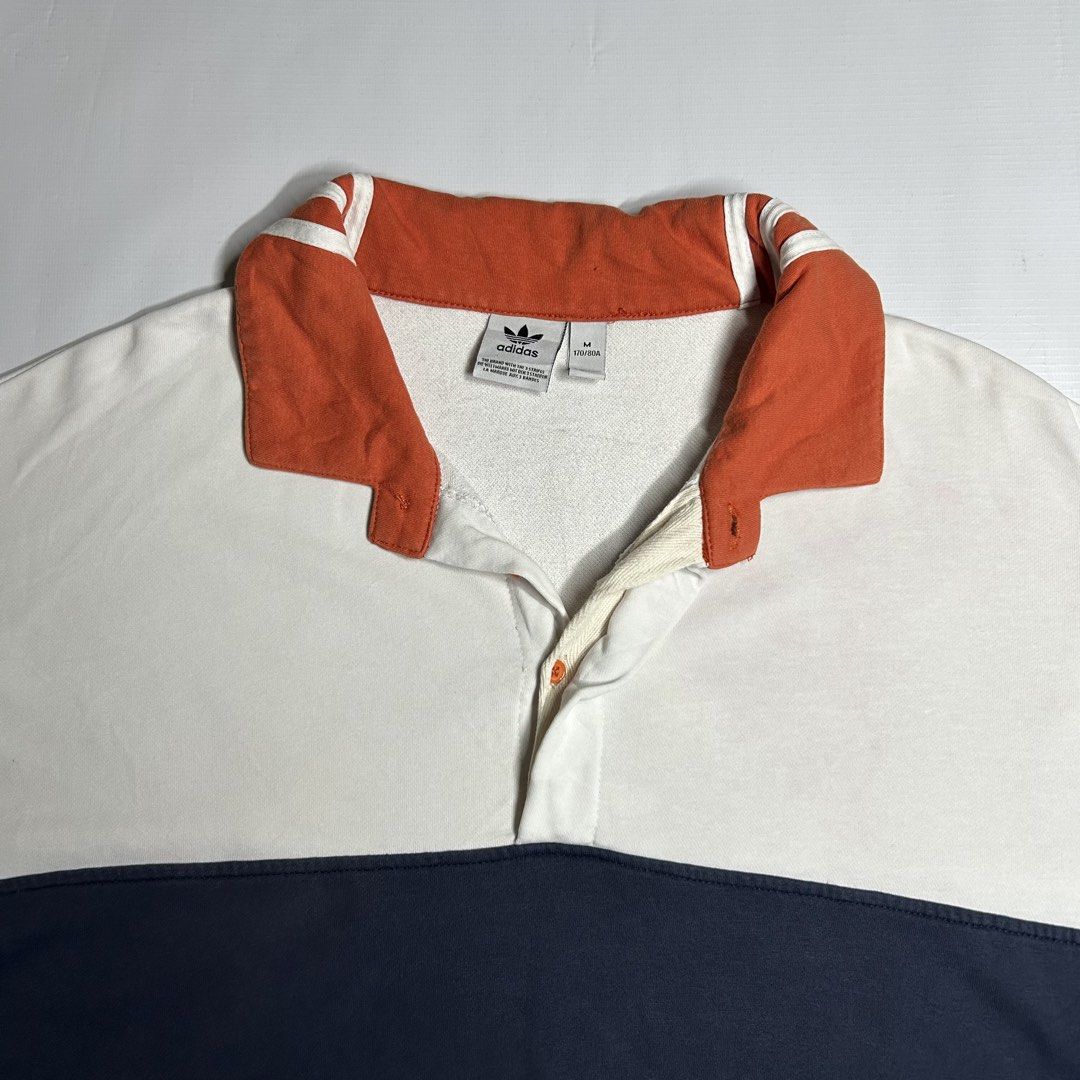 Adidas Quarter Button Sweater (Category: Tshirts & Polo Shirts ) located in Antipolo. Submitted by wvyfrnds (Listing ID 1468751050, Image 2). Description: Adidas Quarter Button Sweater Size: M Color: White/NavyBlue/Peach Dimensions (Inches): Length: 24.5 Width: 24 Color Rate: 9/10 Issues - Light color bleed (Not Visible) 395 PLUS SF.