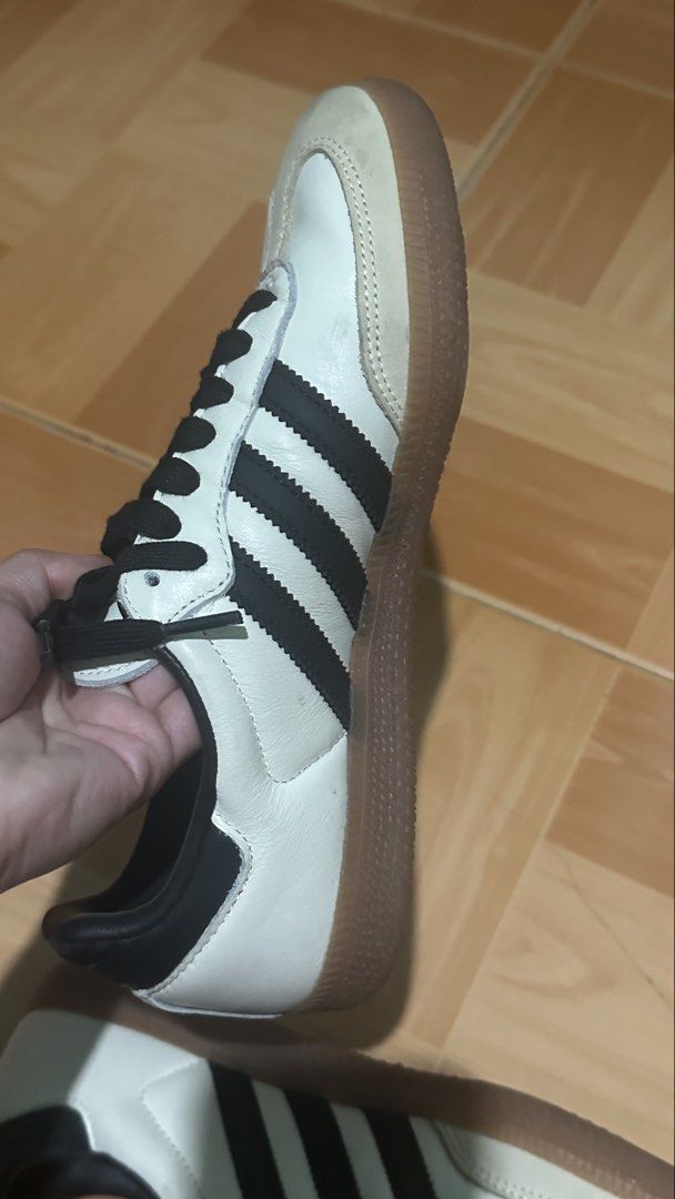 Adidas Samba Cloud White Core Black Shoes (Category: Sneakers) located in Manila. Submitted by declutterwzk (Listing ID 1468807817, Image 2). Description: - Brand: Adidas - Model: Samba - Colorway: White leather with black stripes and iconic gum sole - Details: Suede toe overlays, black heel tab, inner lining, and gold foil Samba branding - Condition: General wear on the suede toe and midsoles, structure and soles remain solid - Inclusions: Comes