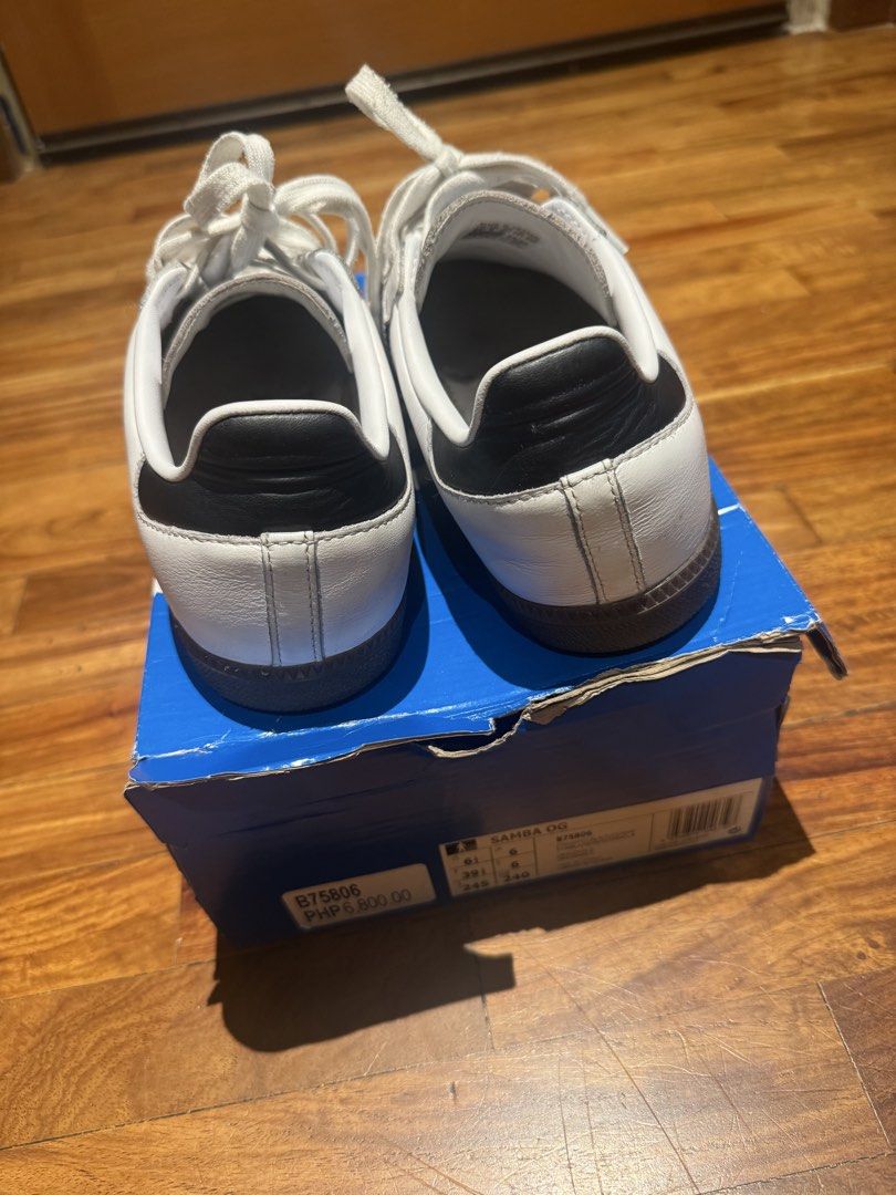 Adidas Samba OG White Black Cloud White B75806 (Category: Sneakers) located in Makati City. Submitted by raremixed (Listing ID 1468846306, Image 3). Description: - Brand: Adidas Samba OG - Colorway: White and Black leather with grey suede toe overlays - Features: Classic gum rubber outsole, blue tongue logo, and iconic gold foil lettering - Condition: Worn a few times, minimal signs of wear on soles and uppers - Inclusions: Original blue Adidas s