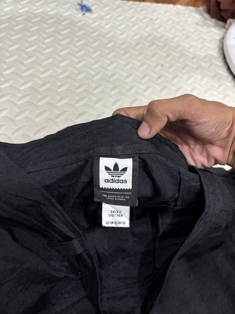 Adidas Skateboarding Cargo Pants Black (Category: Joggers) located in Manila. Submitted by noribrahim.20 (Listing ID 1468874514, Image 3). Description: - Brand: Adidas Skateboarding - Color: Black with subtle all-over hexagon texture - Size: 30/32 (170/76A) - Features: Multiple utility pockets with back brand patches - Fit: Adjustable bungee cords at leg openings - Branding: Classic three stripes on lower leg - Condition: Clean piece with great d