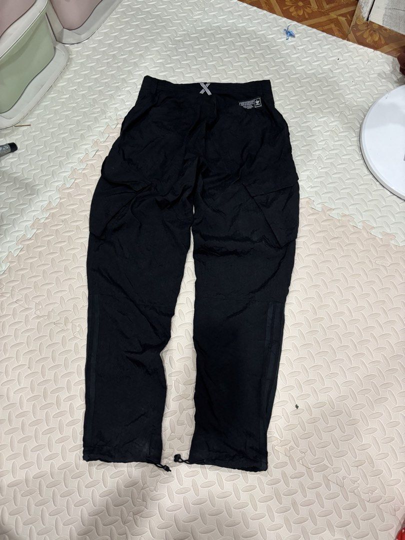 Adidas Skateboarding Cargo Pants Black (Category: Joggers) located in Manila. Submitted by noribrahim.20 (Listing ID 1468874514, Image 2). Description: - Brand: Adidas Skateboarding - Color: Black with subtle all-over hexagon texture - Size: 30/32 (170/76A) - Features: Multiple utility pockets with back brand patches - Fit: Adjustable bungee cords at leg openings - Branding: Classic three stripes on lower leg - Condition: Clean piece with great d