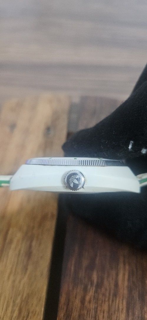 Adidas Stan Smith White Green Watch ADH2931 (Category: Men's Watches) located in Santa Maria. Submitted by rommelmateo (Listing ID 1468860987, Image 3). Description: - Brand: Adidas - Model: ADH2931 (Stan Smith collection) - Dial: White with iconic trefoil logo and green accents - Bezel: bezel with minute markers - Case: White case with trefoil-stamped crown, stainless steel back - Strap: Genuine white leather exterior with bright green embossed-