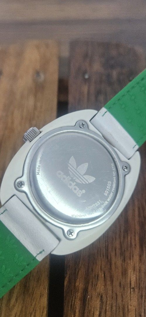 Adidas Stan Smith White Green Watch ADH2931 (Category: Men's Watches) located in Santa Maria. Submitted by rommelmateo (Listing ID 1468860987, Image 2). Description: - Brand: Adidas - Model: ADH2931 (Stan Smith collection) - Dial: White with iconic trefoil logo and green accents - Bezel: bezel with minute markers - Case: White case with trefoil-stamped crown, stainless steel back - Strap: Genuine white leather exterior with bright green embossed-
