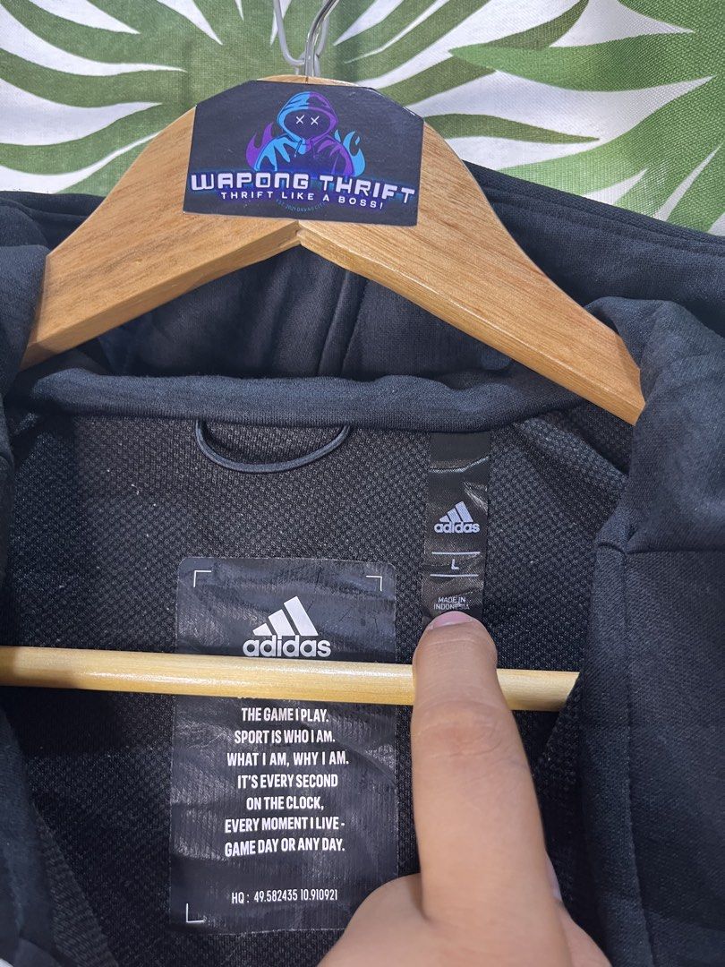 Adidas Techfleece (Category: Coats, Jackets and Outerwear) located in Caloocan City. Submitted by thriftywaps (Listing ID 1468870416, Image 3). Description: - Authentic Adidas full-zip hoodie - Color: Classic black with white accents - Distinctive large Adidas logo printed on the left sleeve - Features a high collar and attached hood for extra coverage - Stylish interior text print detailing inside the back lining - Size: Large (L) | Made in Indo