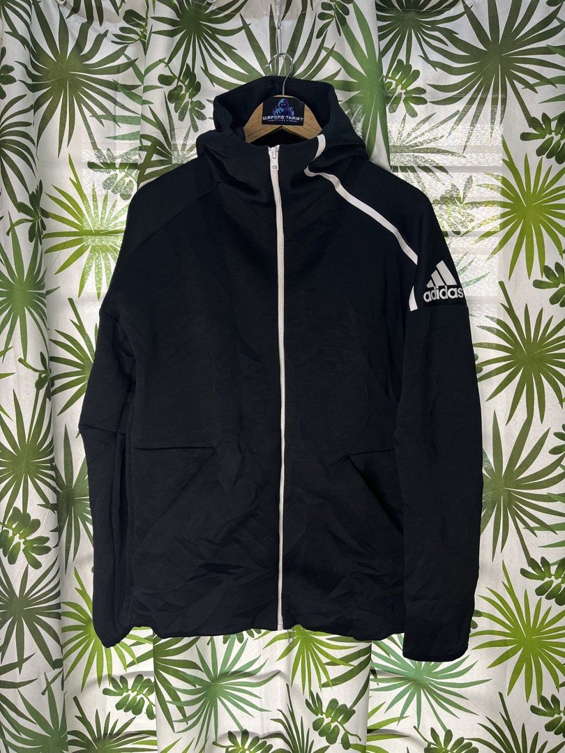 Adidas Techfleece (Category: Coats, Jackets and Outerwear) located in Caloocan City. Submitted by thriftywaps (Listing ID 1468870416, Image 1). Description: - Authentic Adidas full-zip hoodie - Color: Classic black with white accents - Distinctive large Adidas logo printed on the left sleeve - Features a high collar and attached hood for extra coverage - Stylish interior text print detailing inside the back lining - Size: Large (L) | Made in Indo