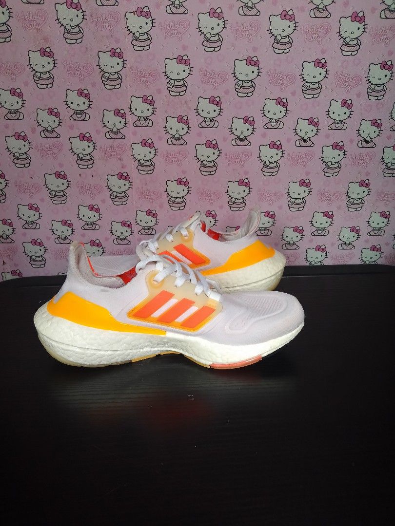 Adidas Ultraboost 22 (Category: Sneakers) located in San Jose del Monte. Submitted by azetor (Listing ID 1468774389, Image 3). Description: Adidas Ultraboost 22 running shoes in a white colorway with vibrant orange and yellow gradient details. Classic Primeknit upper and Boost midsole cushioning. Orange stripes on the midfoot cage and matching heel counter. White laces and orange insoles. - used no box - great condition - perfect for gym running 
