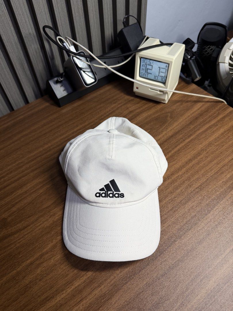 Adidas White Aeroready Baseball Cap (Category: Caps & Hats) located in San Rafael. Submitted by jeremybelza (Listing ID 1468927758, Image 1). Description: - Brand: Adidas - Color: Crisp white with a black logo - Tech: Aeroready moisture-wicking sweatband - Fit: Adjustable strap with a buckle (One size fits most) - Ideal for: Gym workouts, running, or casual daily wear.
