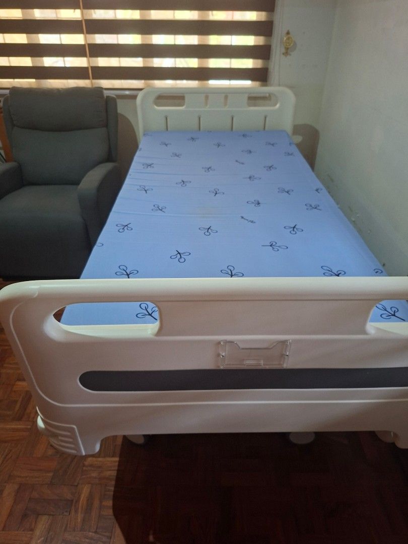 Adjustable Electric Hospital Bed with Mattress (Category: Bed Frames & Mattresses) located in Las Pinas. Submitted by youngbear.fafe9c (Listing ID 1468717653, Image 1). Description: - Cream white adjustable motorized hospital bed - Includes comfortable mattress with blue patterned cover and extra blue mattress (unused) - Handheld wired remote to raise and lower head and foot sections independently - Safety rails that drop down on both sides - Fou