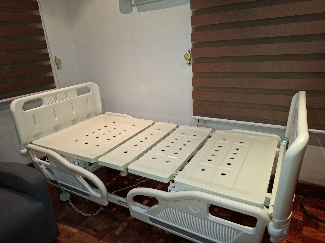 Adjustable Electric Hospital Bed with Mattress (Category: Bed Frames & Mattresses) located in Las Pinas. Submitted by youngbear.fafe9c (Listing ID 1468717653, Image 3). Description: - Cream white adjustable motorized hospital bed - Includes comfortable mattress with blue patterned cover and extra blue mattress (unused) - Handheld wired remote to raise and lower head and foot sections independently - Safety rails that drop down on both sides - Fou