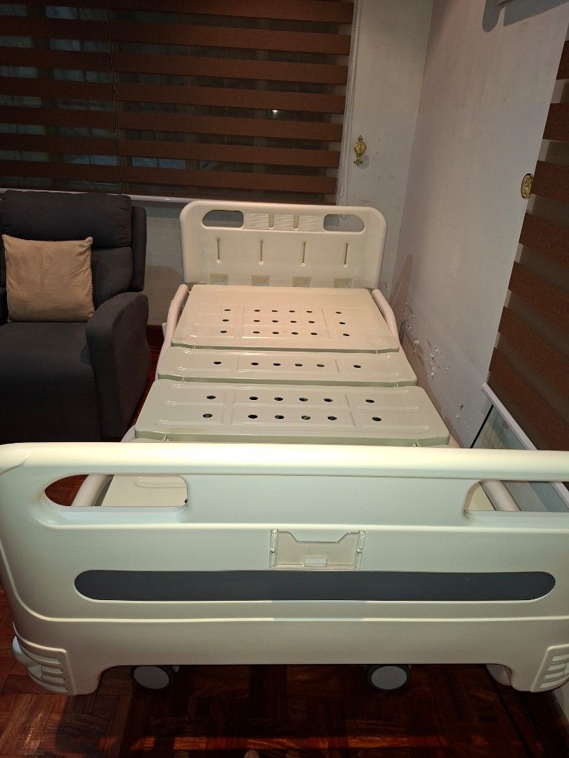 Adjustable Electric Hospital Bed with Mattress (Category: Bed Frames & Mattresses) located in Las Pinas. Submitted by youngbear.fafe9c (Listing ID 1468717653, Image 2). Description: - Cream white adjustable motorized hospital bed - Includes comfortable mattress with blue patterned cover and extra blue mattress (unused) - Handheld wired remote to raise and lower head and foot sections independently - Safety rails that drop down on both sides - Fou