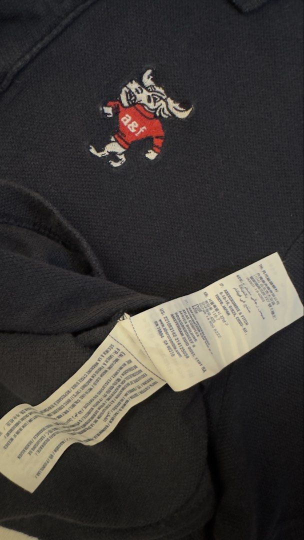A&F (Category: Tshirts & Polo Shirts ) located in Davao. Submitted by kelsocool (Listing ID 1468801862, Image 3). Description: Abercrombie & Fitch Kids Navy Mascot Polo Shirt Size: XL (Fits adult S) Dimes (inch): 27 - length 19 - width 8.5 - sleeve color rate: 9/10 good condition issue - none Description: Abercrombie Kids navy blue polo shirt featuring rare embroidered moose mascot graphic with red A&F sweater..