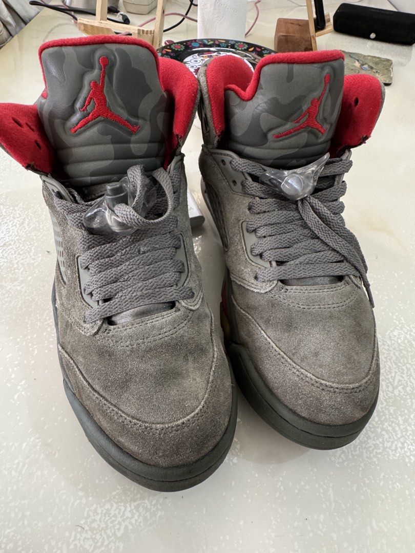 Air Jordan 5 Retro Camo Red (Category: Sneakers) located in Cavite. Submitted by marcuz1316 (Listing ID 1468750010, Image 3). Description: - Model: Nike Air Jordan 5 Retro - Colorway: Dark Grey Suede with Camouflage Print - Details: Vibrant red inner lining, embroidered Jumpman logo on the tongue, and Red Air 23 heel branding - Features: Classic mesh side panels, grey laces with clear lace locks - Sole: Translucent rubber outsole with signature r
