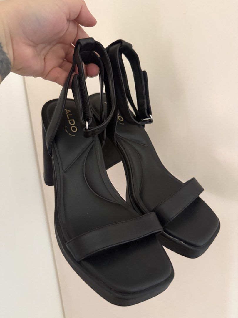 ALDO Berade Black Heeled Sandals (Category: Heels) located in Manila. Submitted by calmpenguin.043b6a (Listing ID 1468745485, Image 1). Description: - Brand: ALDO (Model: Berade) - Color: Classic Black - Heel Type: Chunky block heel with platform sole - Closure: Ankle strap - Comfort: Cushioned Pillow Walk footbed for all-night wear - Condition: Clean, minimal signs of wear on the soles - Styling: Versatile for both dresses and jeans, ideal for e
