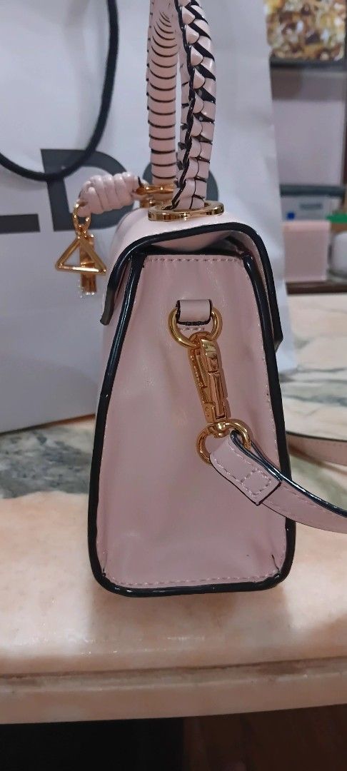 ALDO Pink Crossbody Bag with Top Handle (Category: Cross-body Bags) located in Pasig City. Submitted by elleiram05 (Listing ID 1468806498, Image 1). Description: - Authentic ALDO light pink handbag with chic black trim and gold-tone hardware - Features a trendy braided top handle and a detachable shoulder strap with side clips - Equipped with four protective metal feet on the bottom base - Spacious main compartment with a convenient internal zip 