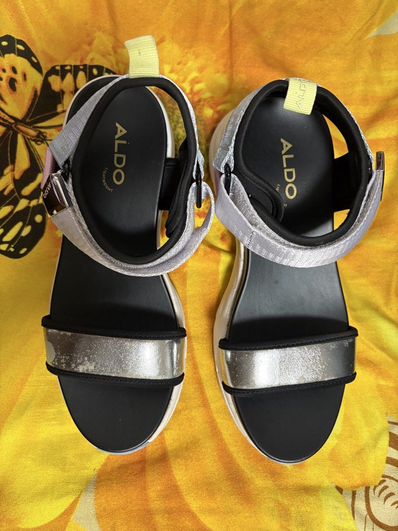 ALDO Platform Sandals Multi-Color Chunky Sole (Category: Sandals) located in Manila. Submitted by nykji96 (Listing ID 1468719948, Image 1). Description: - Brand: ALDO - Style: Platform sandals with chunky soles - Colors: Multi-color straps (silver metallic, pink, and grey webbing) with a black footbed - Closure: Adjustable hook-and-loop ankle straps - Condition: Flaking and wear present on the silver metallic front strap; soles have minor wear wi