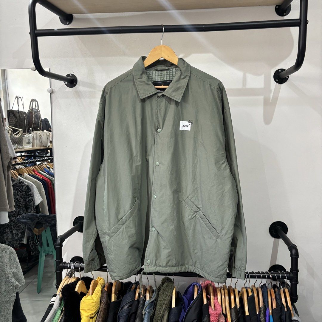 Alpha Industries Airborne Coach Sample Jacket Green XL (Category: Coats, Jackets and Outerwear) located in Bambang. Submitted by heats777 (Listing ID 1468828762, Image 2). Description: - Brand: Alpha Industries - Style: Coach jacket with snap button closure and side pockets - Color: Sage green - Size: XL - Details: Small chest logo patch, large graphic text and map print on the back - Lining: Quilted waffle fleece for extra warmth - Origin: Made 