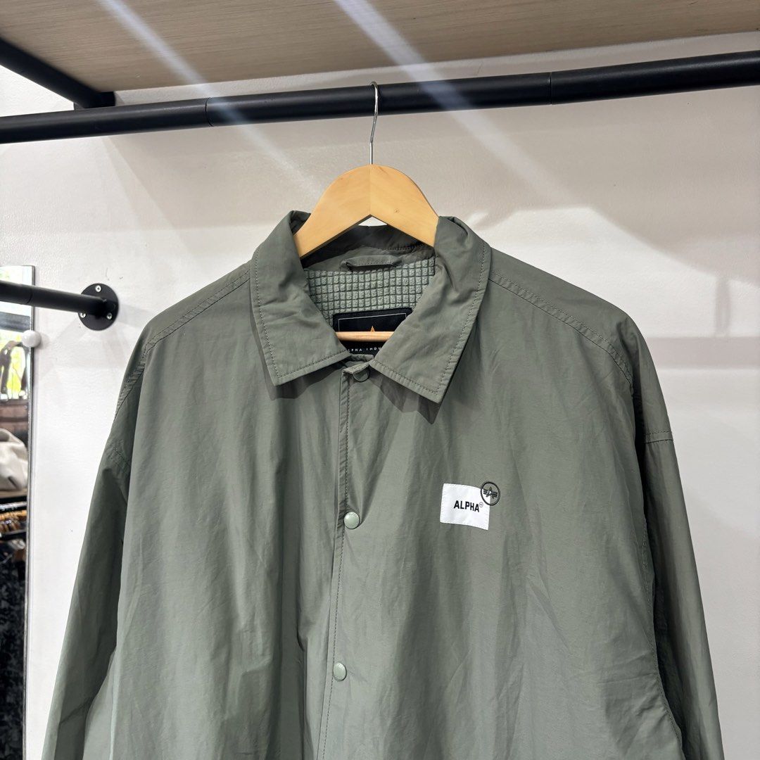 Alpha Industries Airborne Coach Sample Jacket Green XL (Category: Coats, Jackets and Outerwear) located in Bambang. Submitted by heats777 (Listing ID 1468828762, Image 1). Description: - Brand: Alpha Industries - Style: Coach jacket with snap button closure and side pockets - Color: Sage green - Size: XL - Details: Small chest logo patch, large graphic text and map print on the back - Lining: Quilted waffle fleece for extra warmth - Origin: Made 