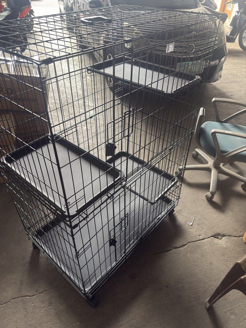 Amazon Basics Large 3-Tier Cat Cage Playpen (Category: Homes & Other Pet Accessories) located in Binan City. Submitted by celestescloset (Listing ID 1468812059, Image 1). Description: - Brand: Amazon Basics Large 3-Tier Cat Cage / Playpen - Material/Color: Sturdy black wire construction - Dimensions: 35.8" x 22.4" x 50.6" - Features: Rolling wheels for easy mobility & foldable design for storage - Convenience: Removable plastic trays for hassle-f
