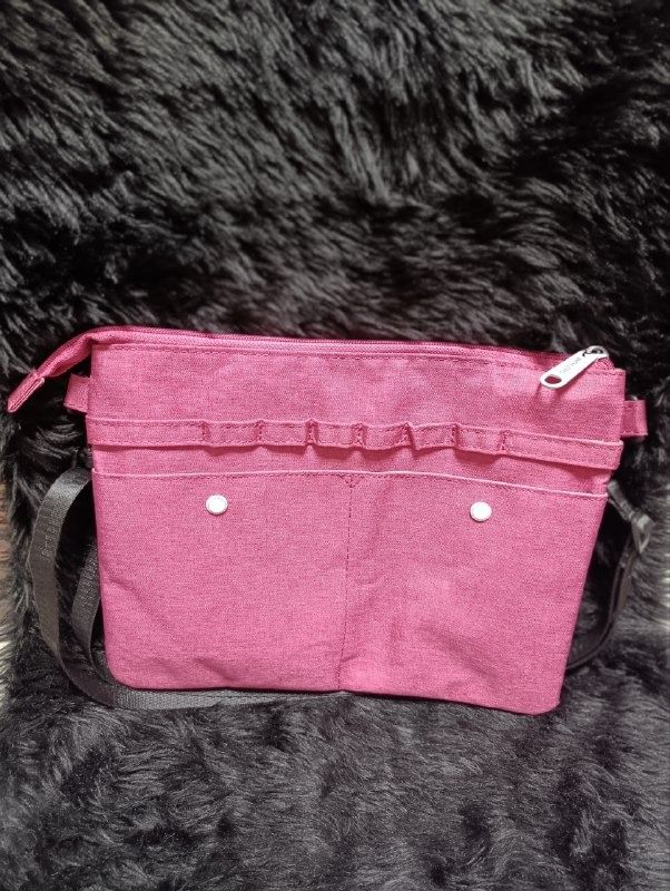 Anello Pink Crossbody Bag with Strap (Category: Cross-body Bags) located in Iloilo. Submitted by jpk_ok_sales (Listing ID 1468798173, Image 2). Description: - Authentic Anello pink crossbody bag made from durable textured fabric - Features a secure main zip closure with a white branded zip pull - Front exterior has double snap-button pockets and handy pen holder loops - Spacious interior lined in beige fabric with convenient slip and zip pockets 