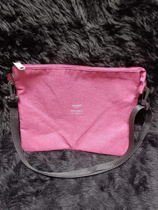 Anello Pink Crossbody Bag with Strap (Category: Cross-body Bags) located in Iloilo. Submitted by jpk_ok_sales (Listing ID 1468798173, Image 1). Description: - Authentic Anello pink crossbody bag made from durable textured fabric - Features a secure main zip closure with a white branded zip pull - Front exterior has double snap-button pockets and handy pen holder loops - Spacious interior lined in beige fabric with convenient slip and zip pockets 