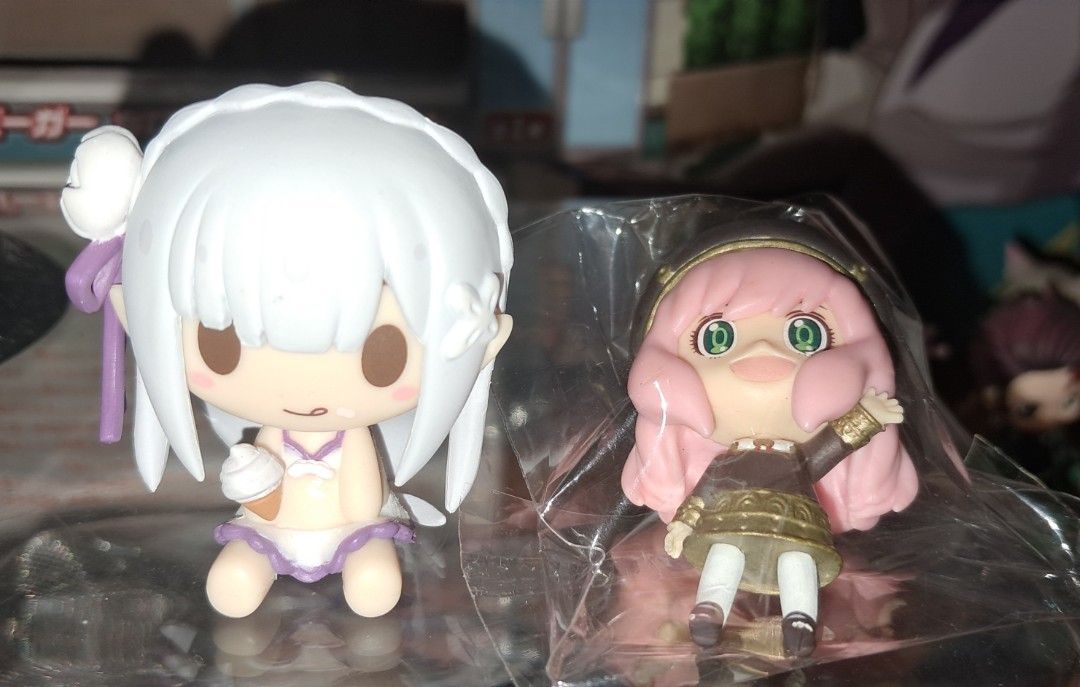 Anime character collectible figures bundle lot (Category: Figurines & Statues) located in Baguio. Submitted by mooncollectibles_000a43 (Listing ID 1468796564, Image 2). Description: - Anime collectible figure bundle - Includes Banpresto Q Posket figure with black stand Ruby Hoshino - Includes purple-haired sitting character in sneakers and jacket - Includes Emilia from Re:Zero in swimwear - Includes one smaller character in a bag - Great addition