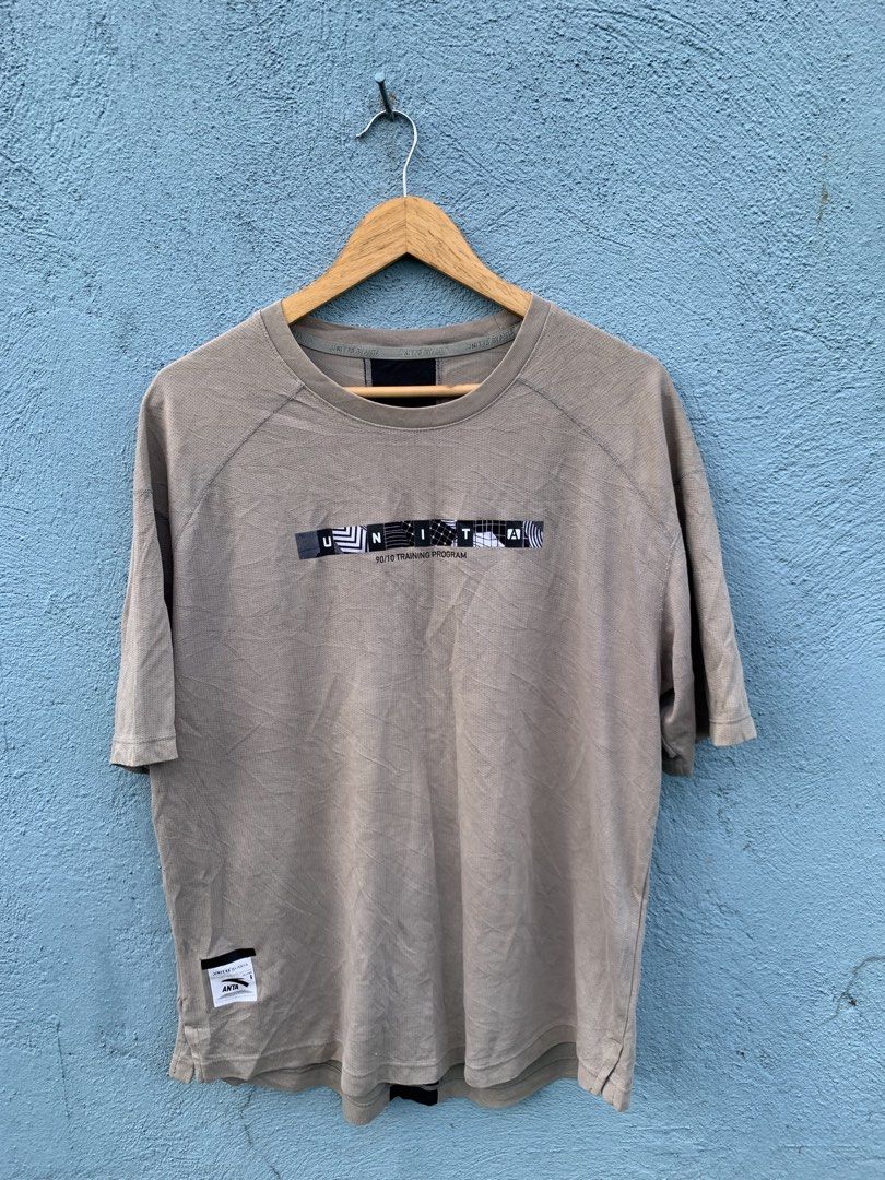Anta Unit A Training Program T-Shirt Beige (Category: Tshirts & Polo Shirts ) located in Manila. Submitted by rommelx-07 (Listing ID 1468787952, Image 1). Description: - Brand: Anta Unit A (90/10 training program) - Color: Light beige - Material: 67% cotton, 33% polyester (soft & breathable) - Design: Short sleeves, crew neck, graphic box print on chest, and woven patch near hem - Unique Detail: Contrast black stripe down the back spine - Conditi