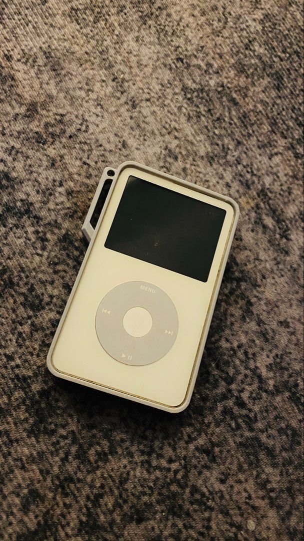 Apple iPod Classic with protective case (Category: Portable Music Players) located in Dasmarinas. Submitted by bbgaminghub (Listing ID 1468810446, Image 2). Description: - Classic Apple iPod in working vintage condition - Screen lights up blue with clear menu options - Click wheel and controls work normally - Battery holds a decent charge - Minor signs of use around the edges - Includes a protective case (charging cable NOT included).