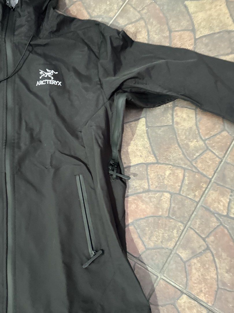Arc'teryx Waterproof Hooded Jacket (Category: Coats, Jackets and Outerwear) located in Imus. Submitted by mikeythrifts (Listing ID 1468843080, Image 3). Description: - Brand: Arc'teryx Waterproof Jacket - Color: Solid Black - Size: Men's 2XL/3XL - Features: Full zip front, adjustable hood with drawcords, pit zips for ventilation, and zipped side pockets - Condition: Lightweight rain shell, perfect for wet weather - Location: Cavite/Makati.