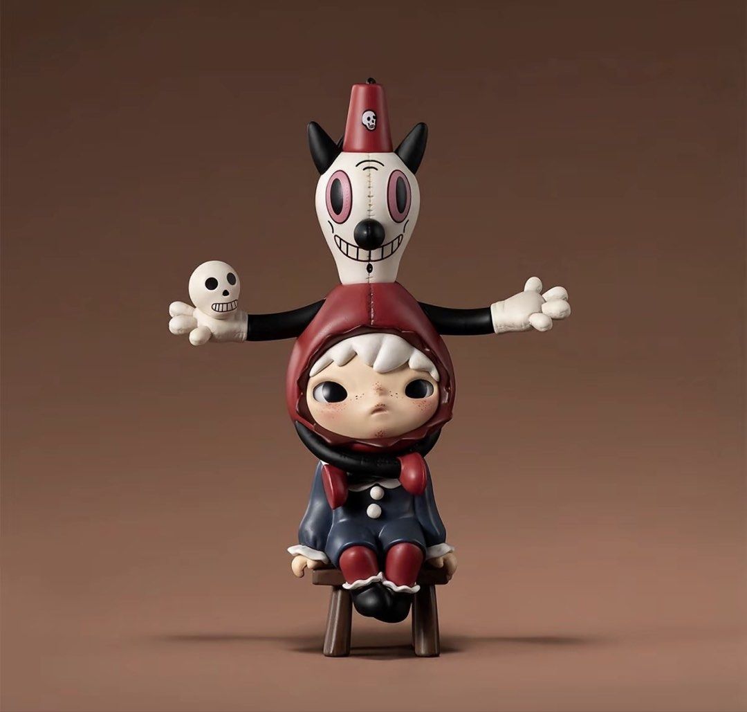 Hirono Gary Baseman Figure (Category: Designer & Blind Box Toys) located in Quezon City. Submitted by martitay02 (Listing ID 1468745037, Image 1). Description: Hirono Gary Baseman Collab - Art toy vinyl figure featuring a unique character on a tiny wooden stool - Upper design: quirky creature with striking pink eyes holding a small skull - Lower design: child figure wearing a charming red hood and blue outfit - Crafted with intricate sculpting an