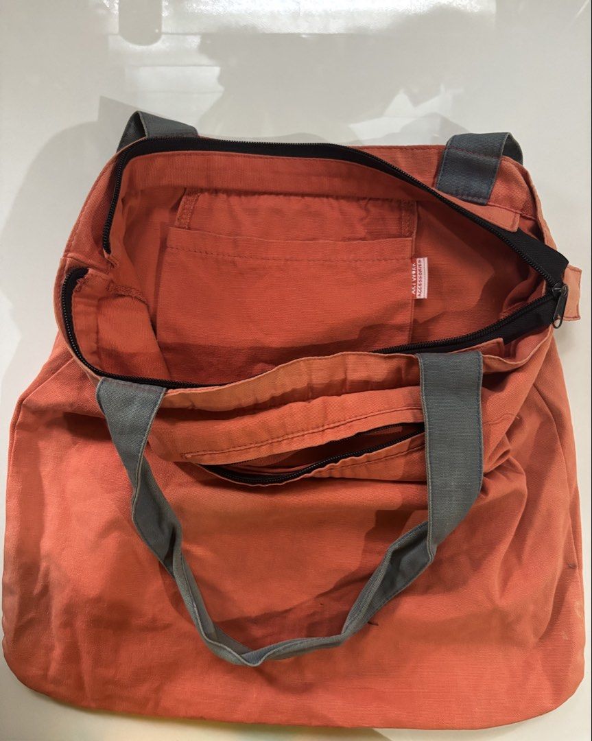 Artwork Accessories Don't Call It A Comeback Canvas Tote (Category: Tote Bags) located in Davao. Submitted by 553club (Listing ID 1468801400, Image 2). Description: - Brand/Item: Artwork Accessories orange canvas tote bag - Design: Bold 'Don't Call It A Comeback' graphic print on the front - Closure & Straps: Secure top zip closure with sturdy grey shoulder straps - Pockets: Includes one interior slip pocket and a small zippered pocket on the bac