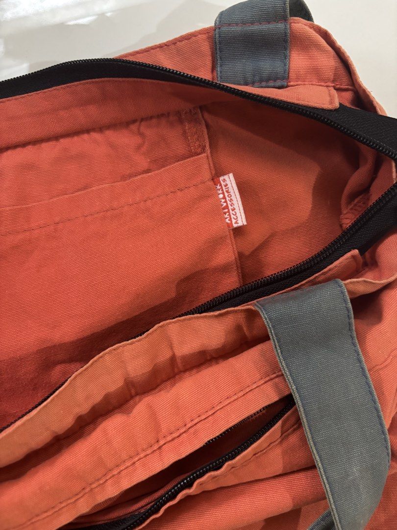Artwork Accessories Don't Call It A Comeback Canvas Tote (Category: Tote Bags) located in Davao. Submitted by 553club (Listing ID 1468801400, Image 3). Description: - Brand/Item: Artwork Accessories orange canvas tote bag - Design: Bold 'Don't Call It A Comeback' graphic print on the front - Closure & Straps: Secure top zip closure with sturdy grey shoulder straps - Pockets: Includes one interior slip pocket and a small zippered pocket on the bac