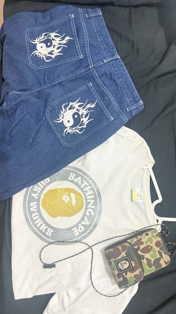 ASPACK ONLY (Category: Tshirts & Polo Shirts ) located in Manila. Submitted by harveyyay07523 (Listing ID 1468876107, Image 1). Description: - Complete streetwear starter kit - White A Bathing Ape Busy Works t-shirt with gold ape head graphic - Blue denim jeans featuring white flaming yin yang symbols on back pockets - Green camo crossbody phone bag - All pieces shown in photos are included - Sold as a bundle set.