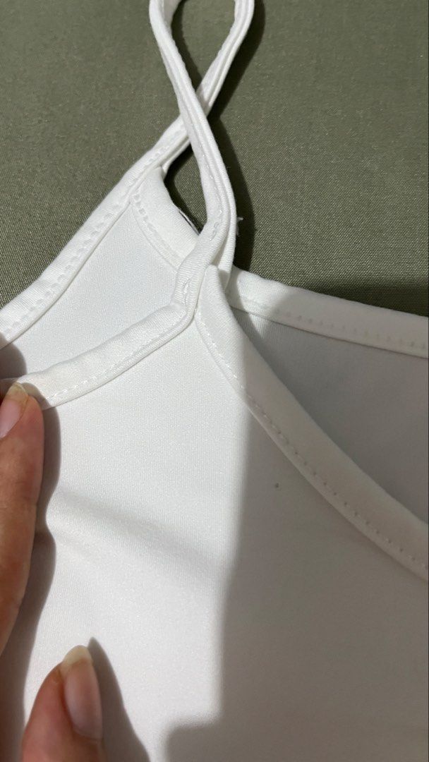 Augety White Spaghetti Strap Camisole Tank Top (Category: Sleeveless) located in Cebu City. Submitted by minymal (Listing ID 1468904160, Image 2). Description: - Color: Classic White - Design: Scoop neckline with thin spaghetti straps - Material: Soft and stretchy fabric for all-day comfort - Quality: Clean stitching along the edges - Versatility: Great basic piece for layering or wearing on its own.