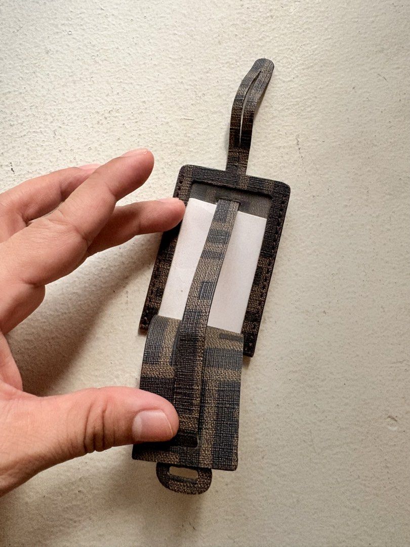 Authentic Fendi FF Zucca Bag Tag (Category: Luxury Bags & Wallets) located in Mandaluyong City. Submitted by wear_your_style (Listing ID 1468794309, Image 3). Description: Bought in Japan. Coated canvas material/PVC. Perfect for your carry-on luggage or sa everyday bag mo. You can insert your ID or photo inside for identifier. Approx 3.2 inches long and 2.2 inches wide. Flat type. No issues, signs if use if any. RFS: decluttering.