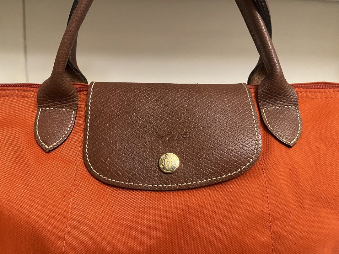 Authentic Longchamp Le Pliage – Orange (Category: Purses & Pouches) located in Manila. Submitted by bellejnc (Listing ID 1468811868, Image 3). Description: Decluttering sale because I’m moving out of the country! ✈️ Selling some of my personal belongings and hoping they find a new home. ✨ Authentic Longchamp Le Pliage 🧡 Color: Orange 🇪🇺 Purchased in Europe 💰 Selling for only ₱3,000 Condition: Pre-loved. There is a stain on the bag that may be