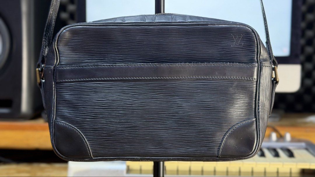Authentic Louis Vuitton Epi Leather Black Shoulder Bag (Category: Luxury Bags & Wallets) located in Caloocan City. Submitted by prof_music1979 (Listing ID 1468794797, Image 1). Description: - Authentic Louis Vuitton shoulder bag in black Epi leather - Features iconic embossed LV monogram and gold-tone hardware - Convenient exterior front slip pocket and secure top zip closure - Adjustable leather strap with sturdy brass hardware - Dark fabric-lin