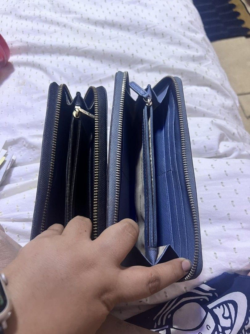 Authentic Michael Kors and Tory Burch Zip Wallets (Category: Wallets & Card holders) located in Manila. Submitted by asissaleh35322 (Listing ID 1468899265, Image 3). Description: - 2-in-1 designer wallet bundle for everyday use - 1st Wallet: Blue Michael Kors embossed leather with silver hardware - 2nd Wallet: Black Tory Burch textured leather with gold hardware and centered logo - Both feature secure zip-around closure - Interior includes multip